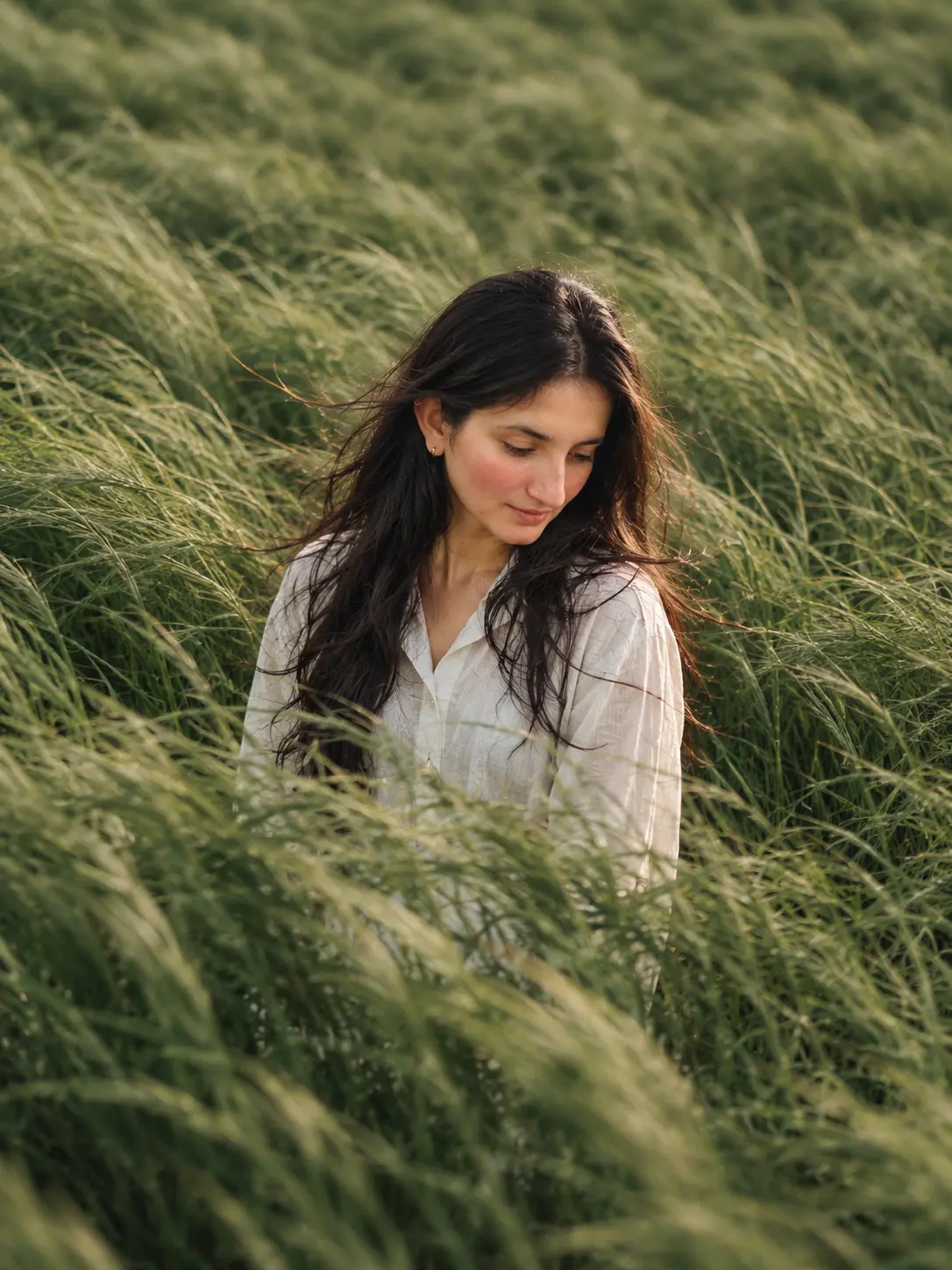 Serene Portrait in Wind-Swept Grasses